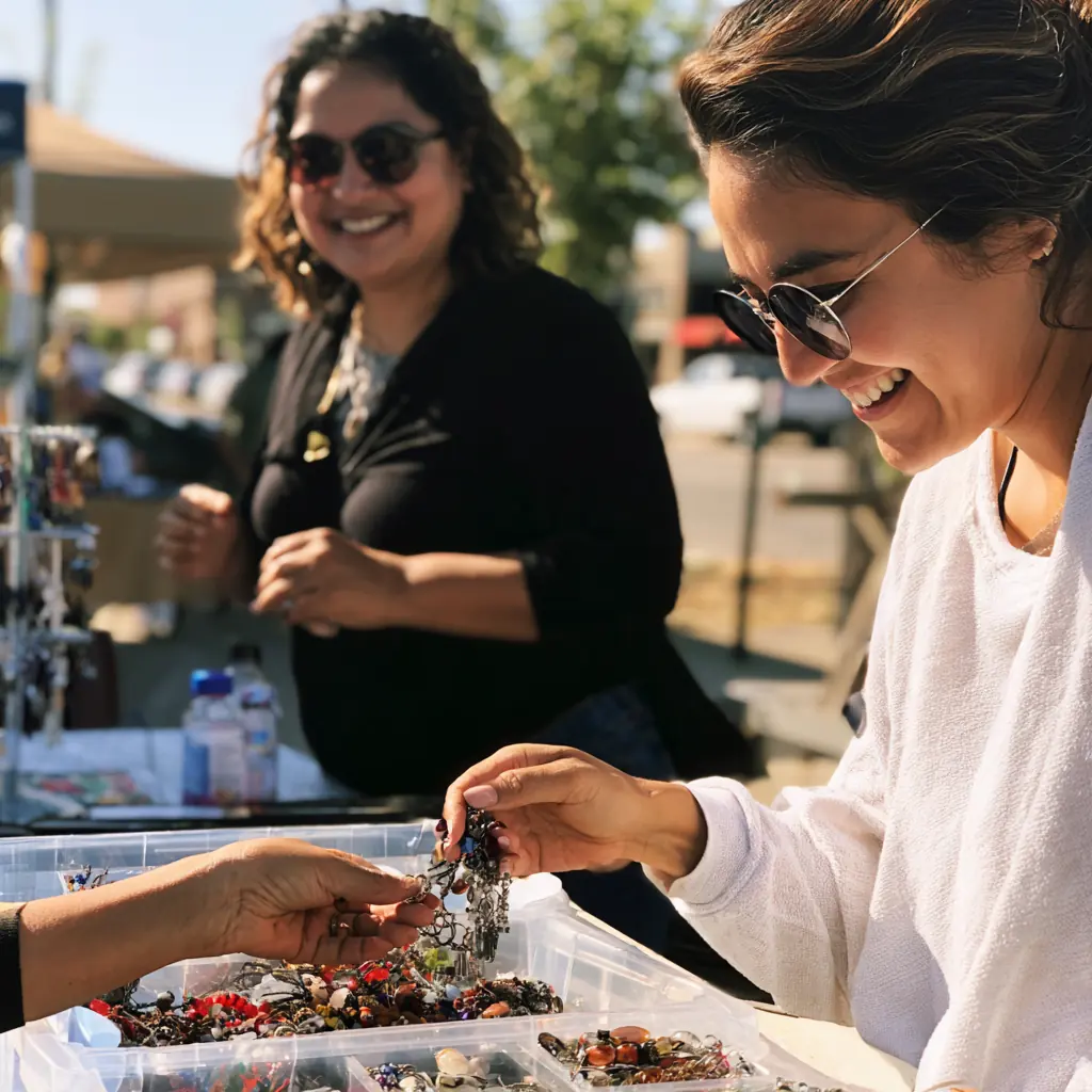 Daniela smiling while a customer picks beads from a tray
