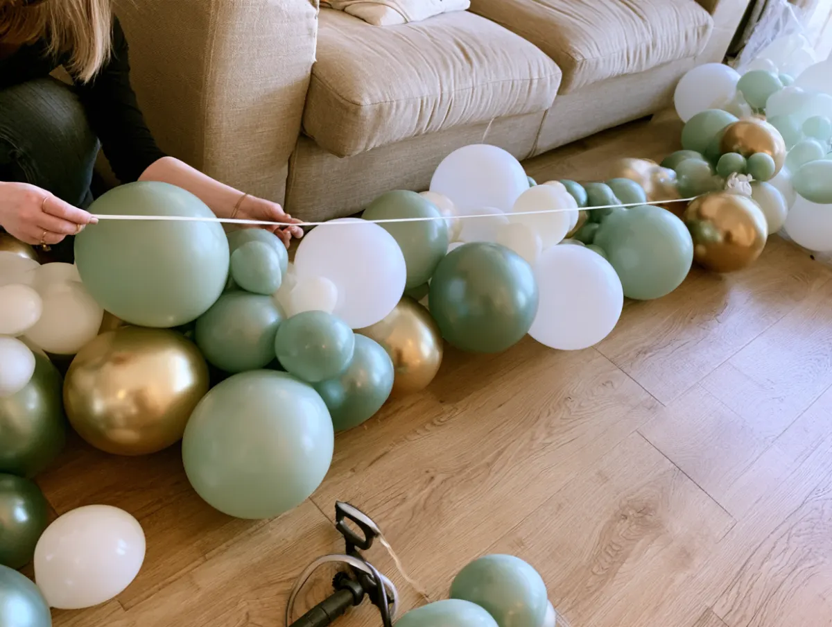 A DIY balloon garland kit spread on the floor