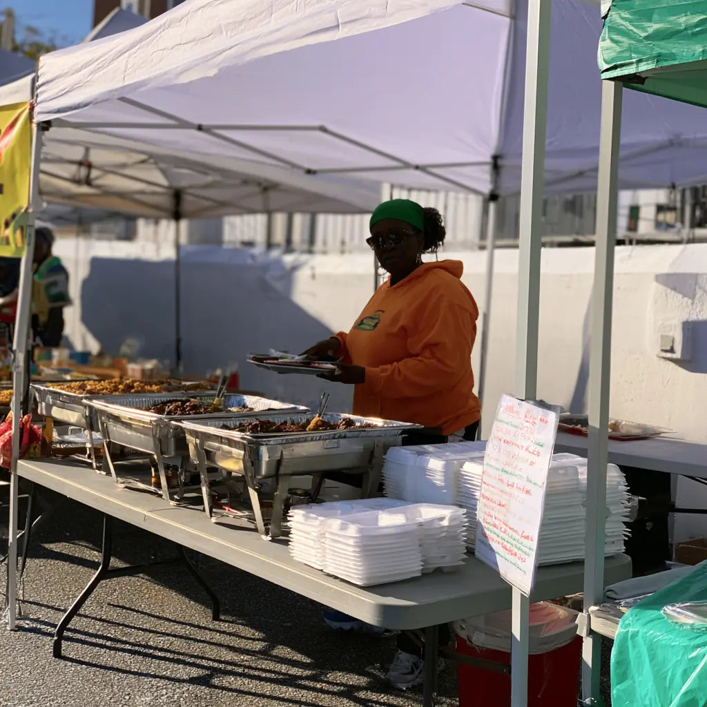 The food stand with steam trays and a handwritten menu board
