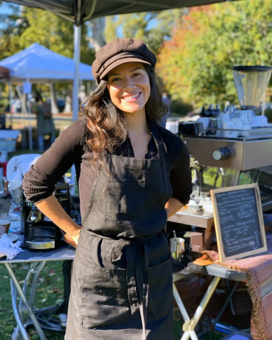Valeria, the owner, behind her espresso cart at an outdoor market
